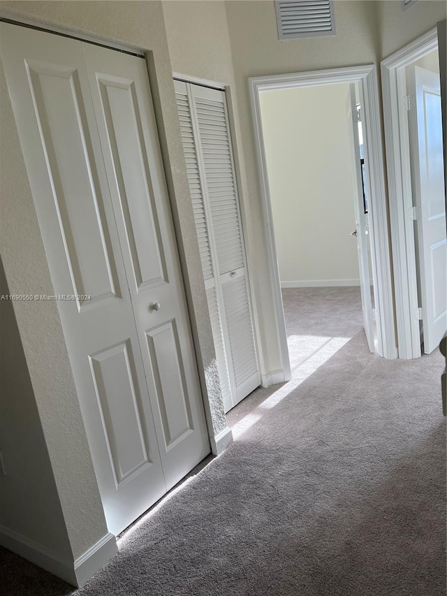 hallway with light carpet