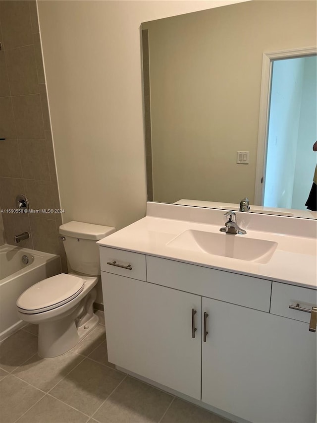 full bathroom with toilet, vanity, tiled shower / bath, and tile patterned floors