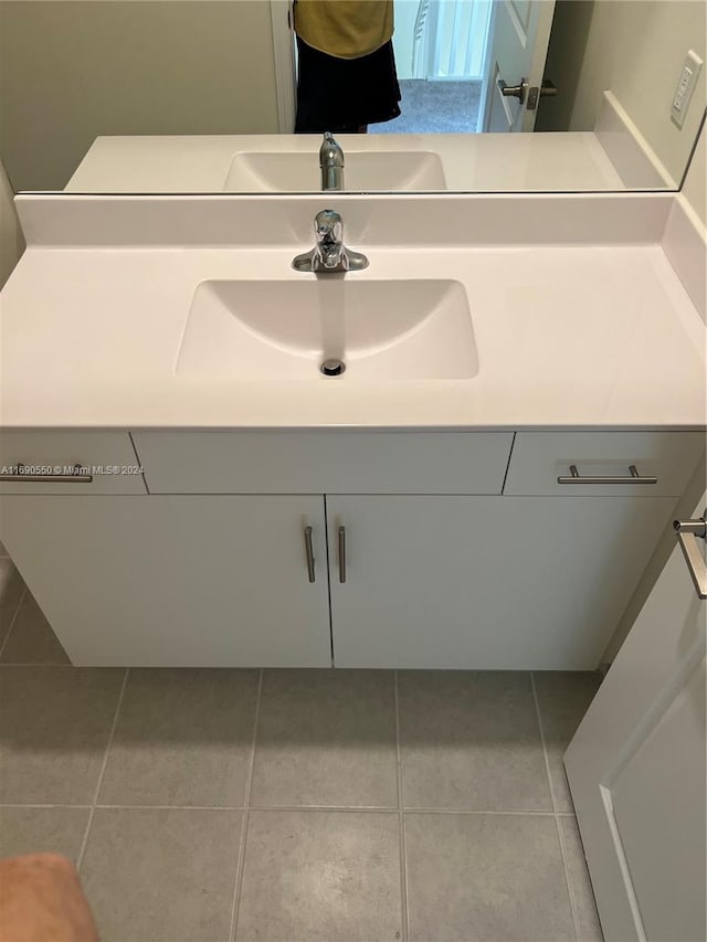 bathroom with tile patterned flooring and vanity