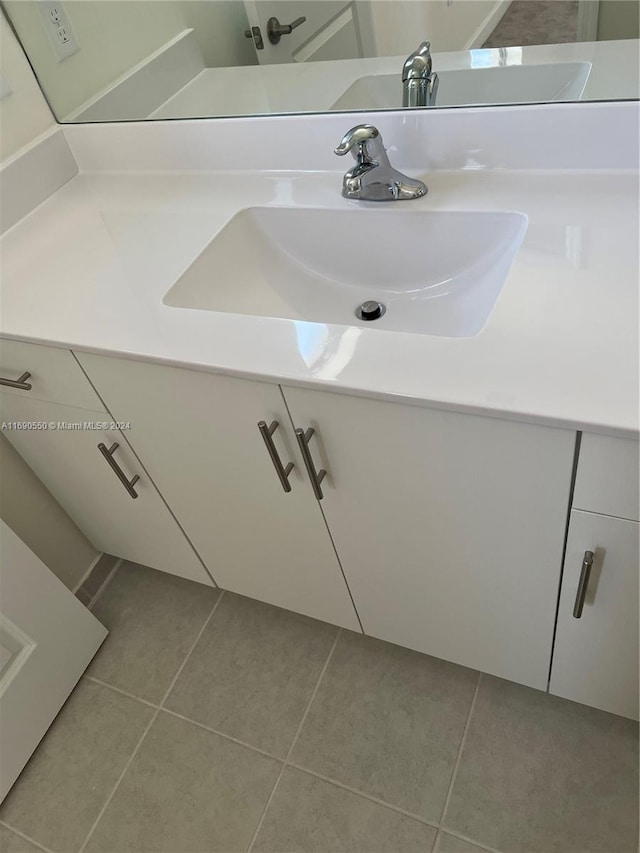 bathroom featuring tile patterned flooring and vanity