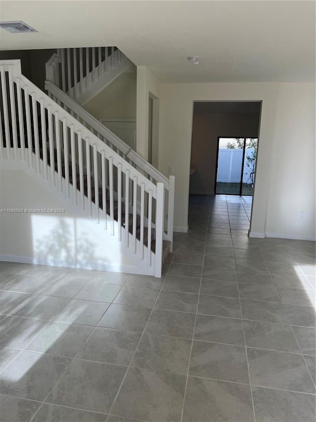 stairway with tile patterned flooring