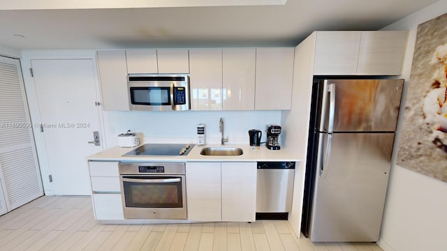 kitchen featuring white cabinetry, appliances with stainless steel finishes, and sink