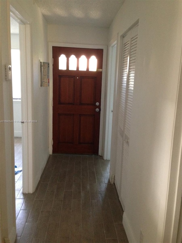 entrance foyer featuring dark wood-type flooring and a textured ceiling