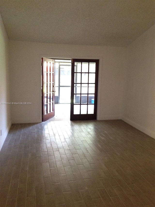 spare room with dark hardwood / wood-style floors