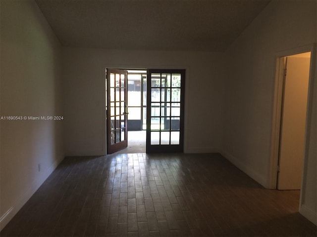 unfurnished room featuring dark wood-type flooring and french doors