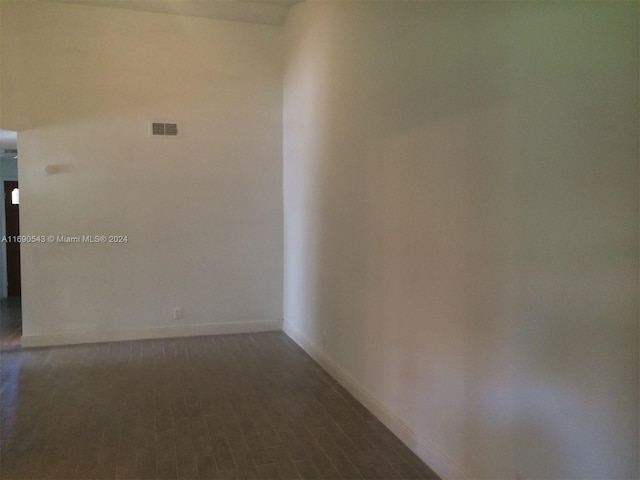 unfurnished room with dark hardwood / wood-style floors