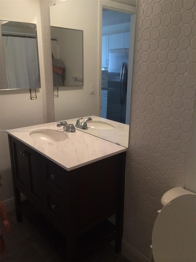 bathroom with tile patterned floors, vanity, and toilet