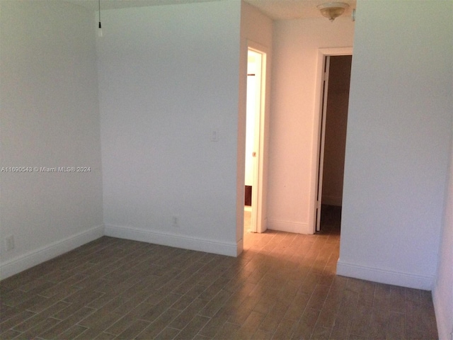 spare room featuring dark wood-type flooring