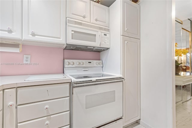 kitchen with white cabinets and white appliances