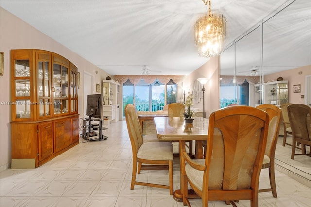 dining room with ceiling fan with notable chandelier