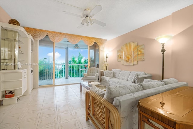 living room with ceiling fan and a textured ceiling