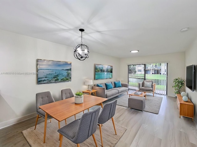 dining area with a chandelier and light hardwood / wood-style floors