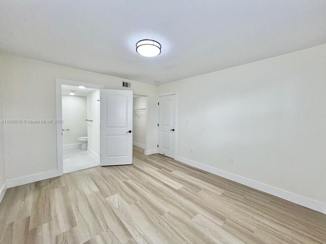 empty room with light hardwood / wood-style floors