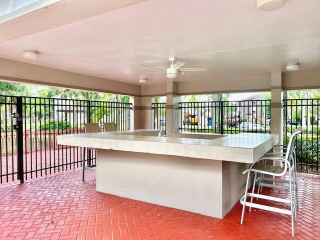 view of patio with an outdoor bar and ceiling fan