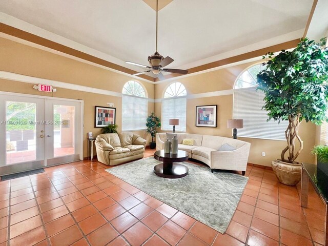 living room with tile patterned floors, french doors, and a healthy amount of sunlight