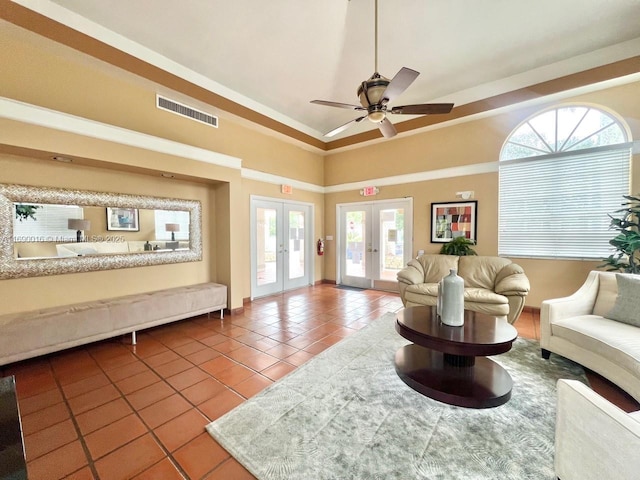 tiled living room with ceiling fan, french doors, and ornamental molding