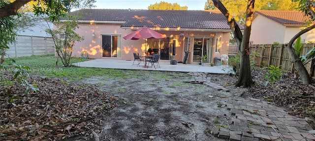 rear view of property featuring a patio area