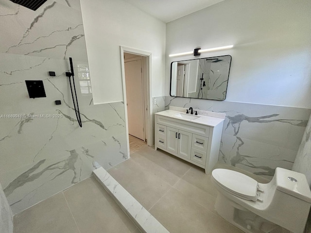 bathroom with a shower, vanity, and toilet