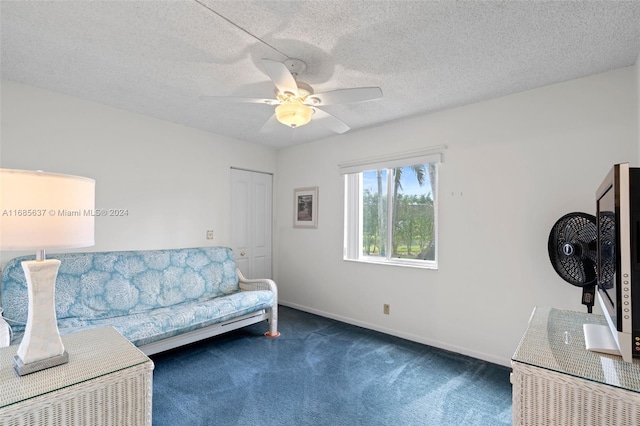 carpeted living room with ceiling fan and a textured ceiling