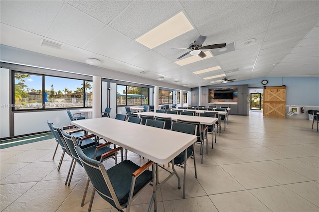 dining room featuring plenty of natural light, ceiling fan, vaulted ceiling, and light tile patterned floors