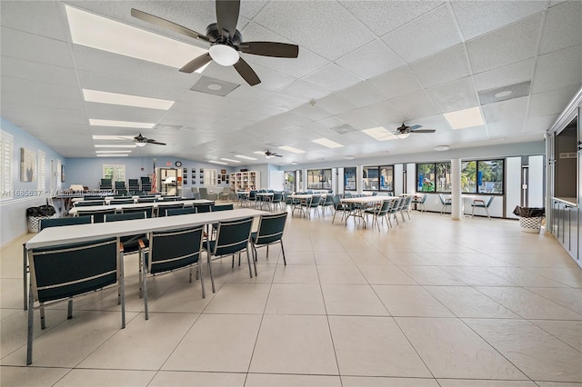 dining area featuring light tile patterned flooring and a drop ceiling