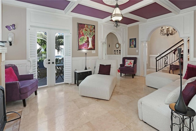 living room with coffered ceiling, french doors, ornate columns, and crown molding