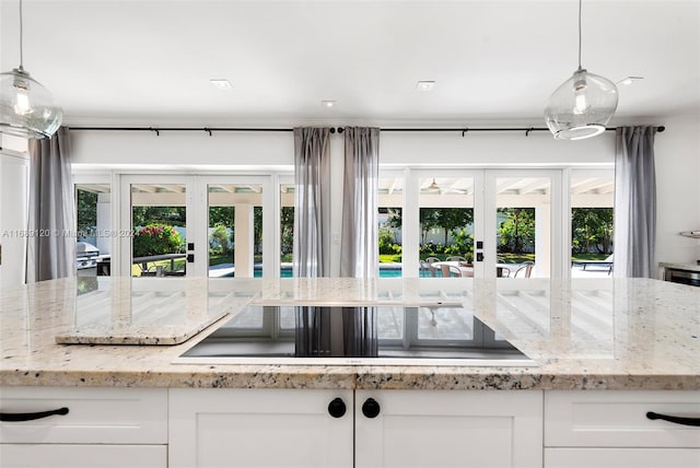 kitchen featuring pendant lighting, french doors, and white cabinets