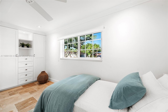 bedroom with ceiling fan and crown molding