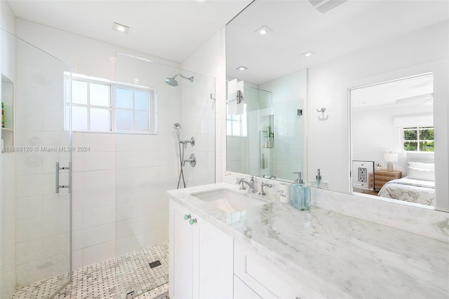 bathroom featuring walk in shower and vanity