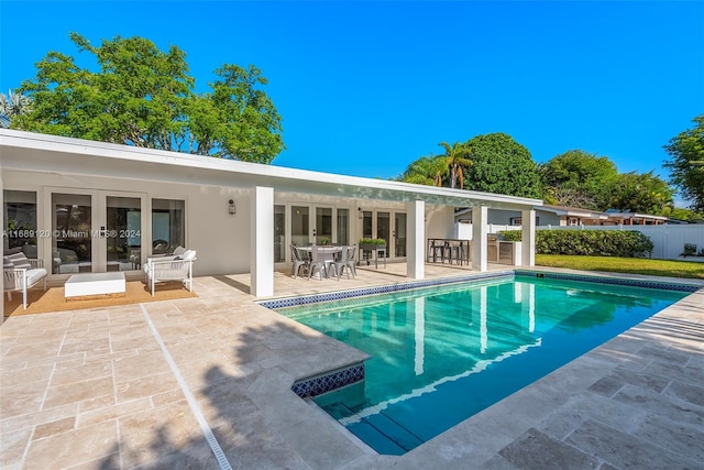 view of pool featuring a patio and french doors