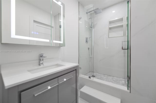 bathroom with walk in shower and vanity