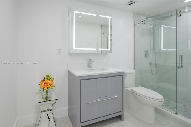 bathroom featuring toilet, an enclosed shower, vanity, and tile patterned flooring