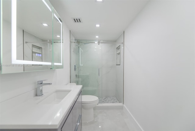 bathroom featuring a shower with door, vanity, and toilet