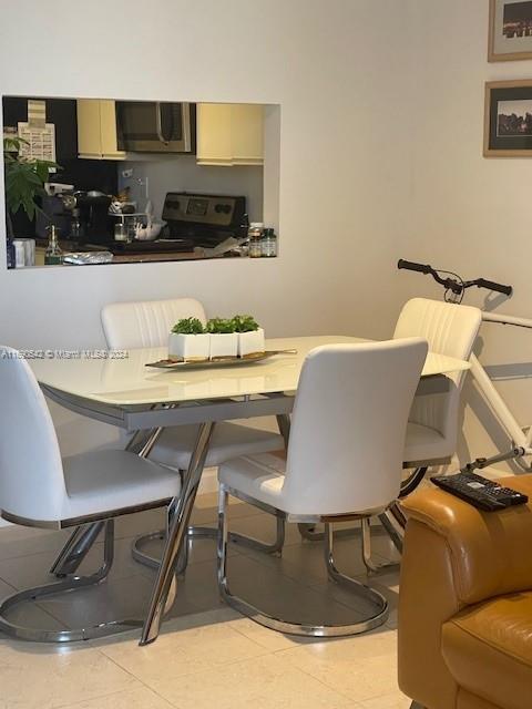 dining space featuring light tile patterned floors