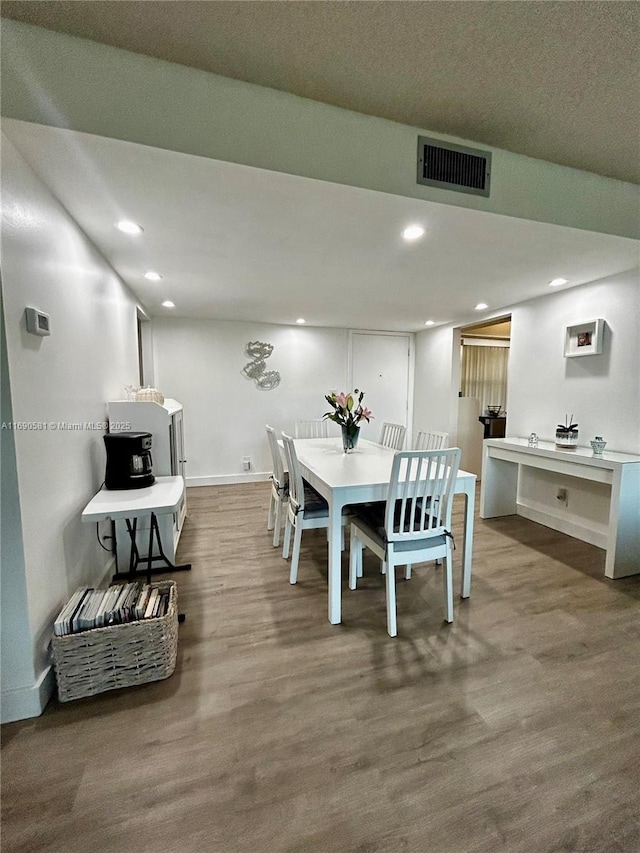 dining area featuring wood-type flooring