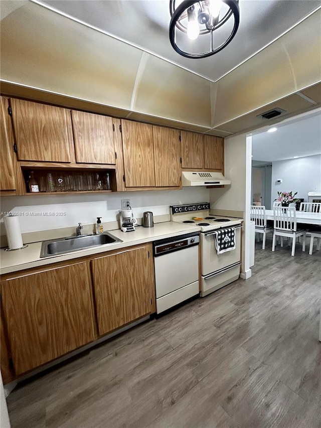 kitchen featuring dark hardwood / wood-style flooring, sink, and white appliances