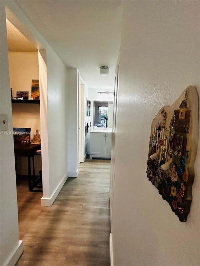 corridor with light hardwood / wood-style flooring