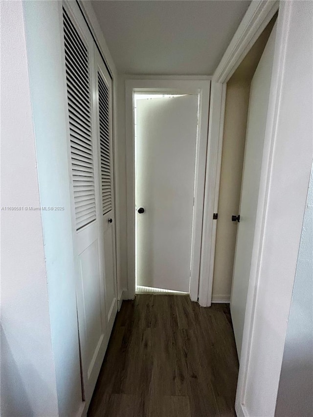 hallway with dark hardwood / wood-style floors