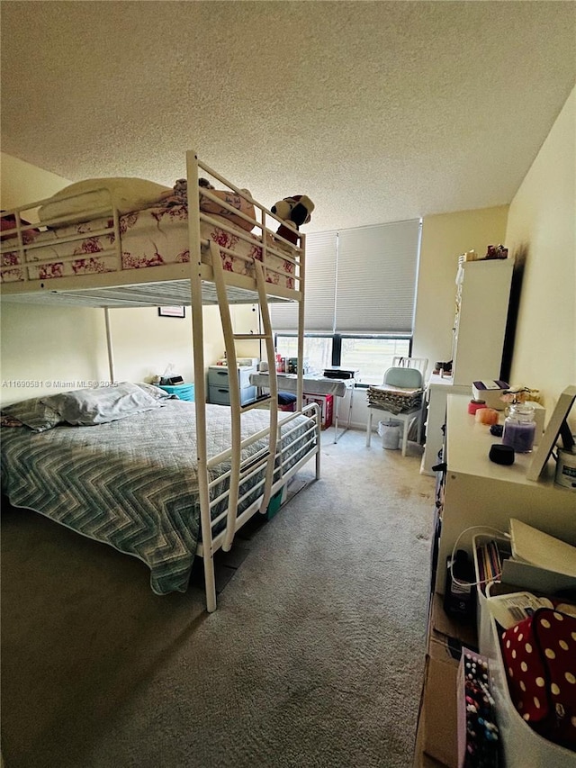 carpeted bedroom with a textured ceiling