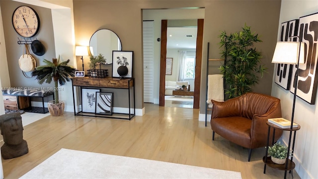 sitting room with hardwood / wood-style flooring