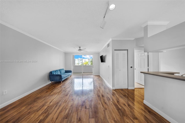 unfurnished room featuring ceiling fan, dark hardwood / wood-style flooring, and ornamental molding