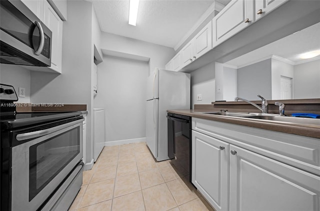 kitchen featuring white cabinetry, light tile patterned floors, crown molding, and stainless steel appliances