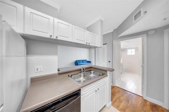 kitchen featuring white cabinets, light hardwood / wood-style flooring, sink, and dishwasher