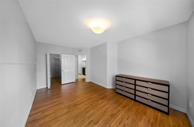 17125 N Bay Rd Unit 3301, Sunny Isles Beach, FL 33160 - unfurnished bedroom featuring baseboards, wood finished floors, and a spacious closet
