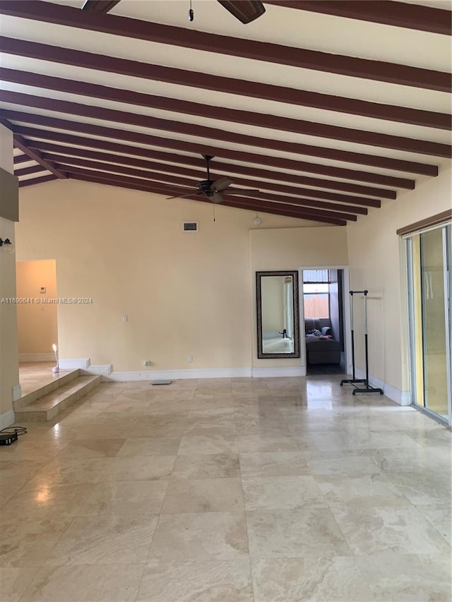 unfurnished room with ceiling fan and lofted ceiling with beams