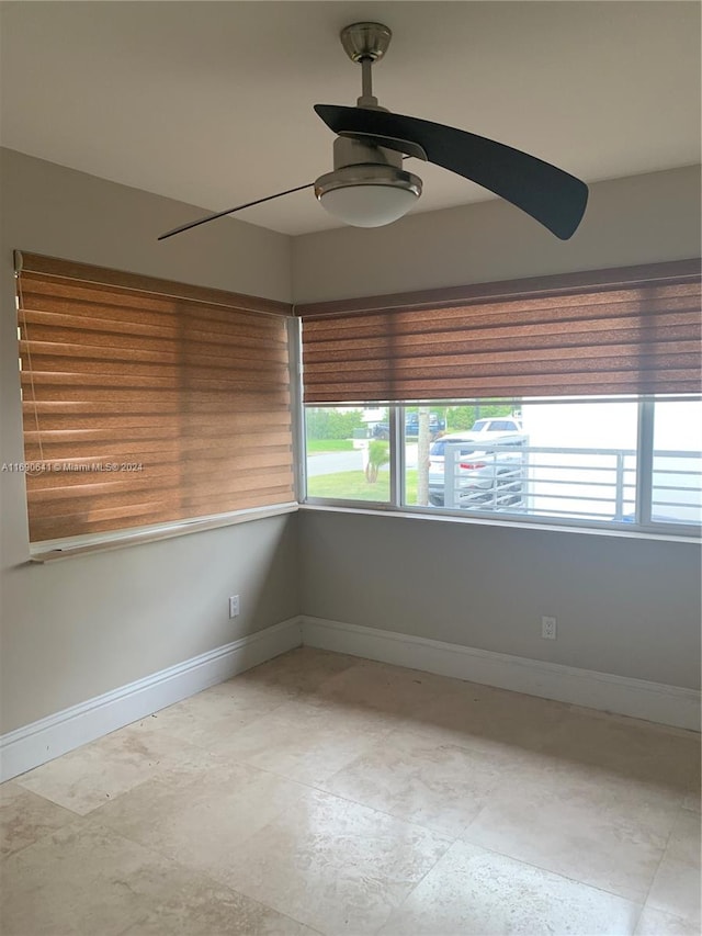 unfurnished room with ceiling fan