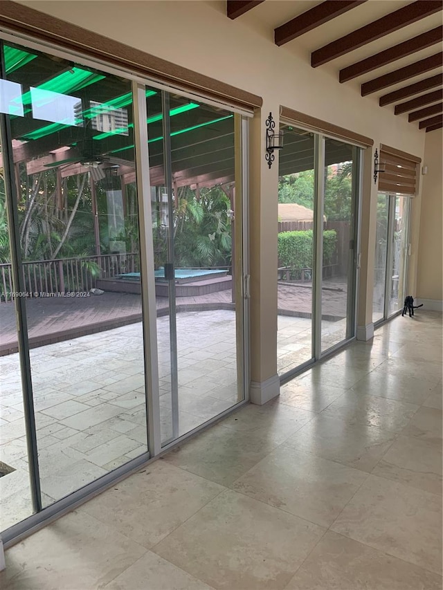 entryway with beamed ceiling