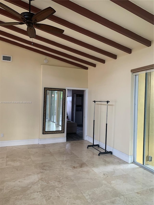 spare room with vaulted ceiling with beams and ceiling fan