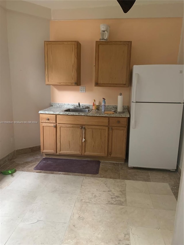 kitchen featuring sink and white fridge