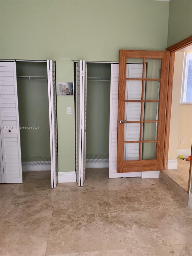 unfurnished bedroom with multiple closets